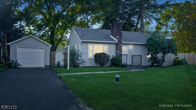 view of front facade featuring an outbuilding, a garage, and a front lawn