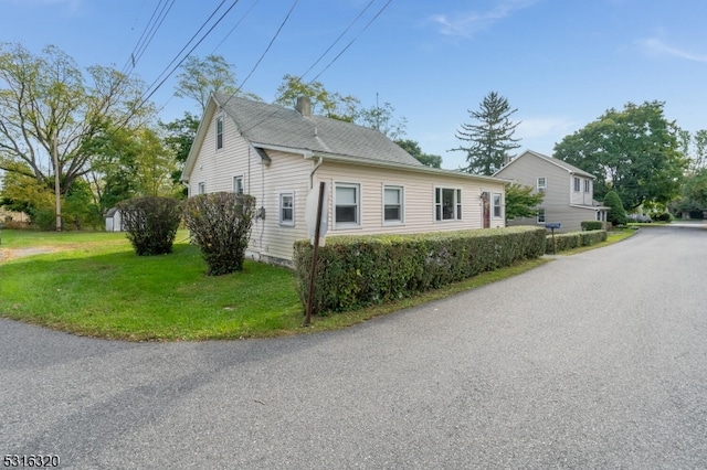 view of side of home featuring a lawn