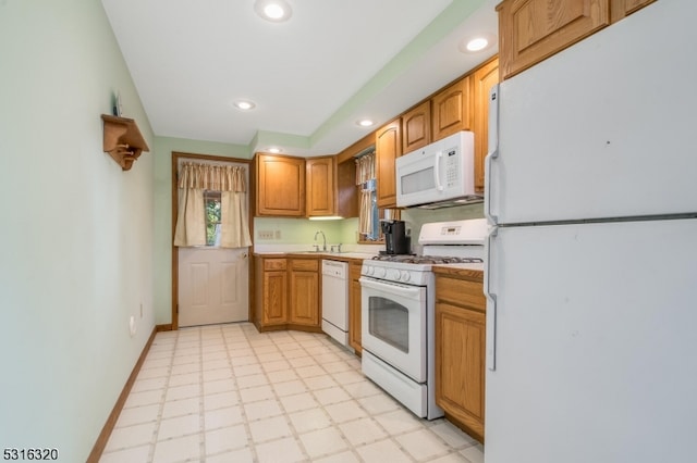 kitchen featuring white appliances and sink