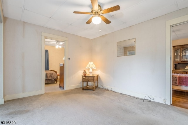 unfurnished room with ceiling fan and light carpet