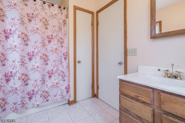 bathroom featuring tile patterned flooring and vanity