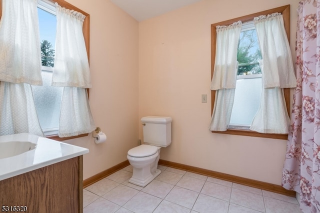 bathroom featuring vanity, toilet, and tile patterned floors