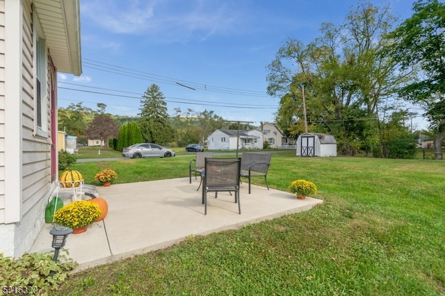 view of yard with a storage shed and a patio