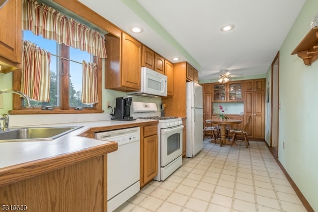 kitchen with ceiling fan, white appliances, and sink