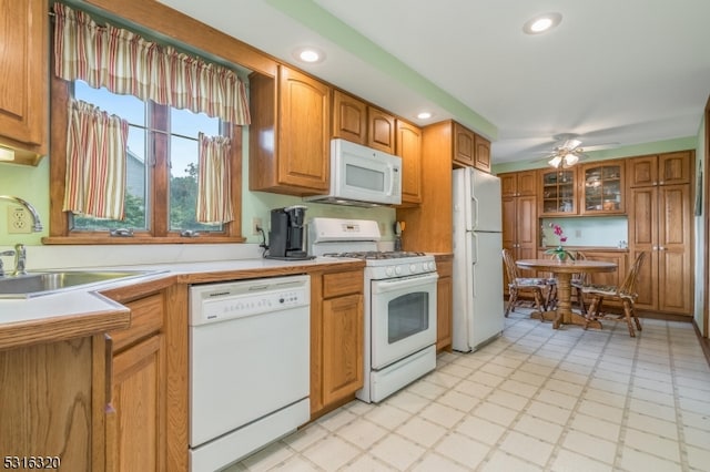 kitchen with ceiling fan, white appliances, and sink