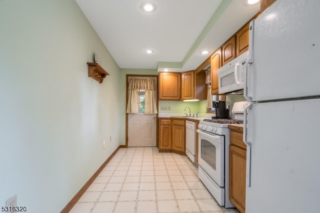 kitchen featuring sink and white appliances