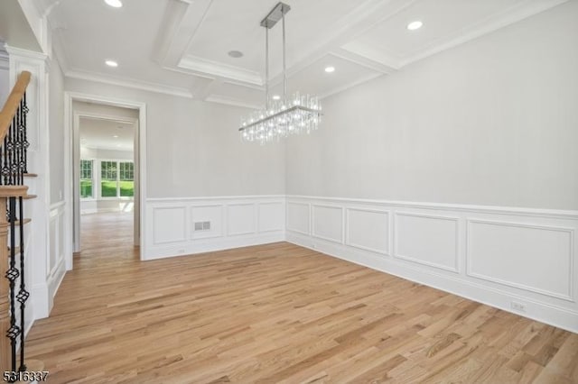 unfurnished dining area with coffered ceiling, beam ceiling, light hardwood / wood-style flooring, and ornamental molding