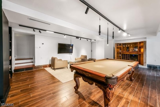 rec room featuring a bar, pool table, track lighting, and wood finished floors