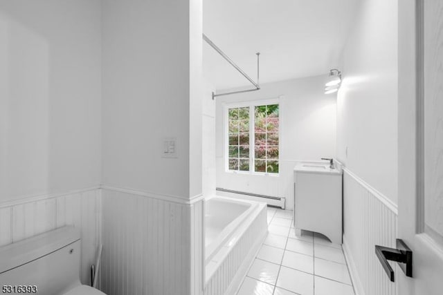 full bathroom featuring toilet, a wainscoted wall, a baseboard heating unit, vanity, and a garden tub