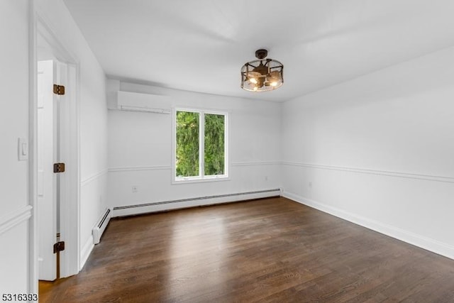spare room featuring baseboards, a wall mounted air conditioner, an inviting chandelier, and wood finished floors