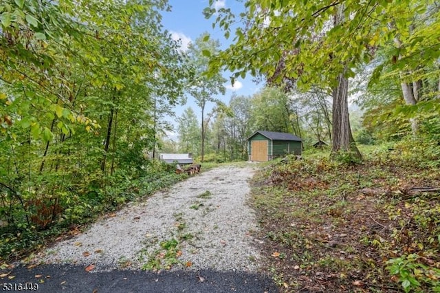 view of road with gravel driveway