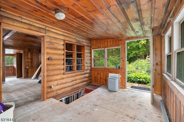 unfurnished sunroom featuring wooden ceiling