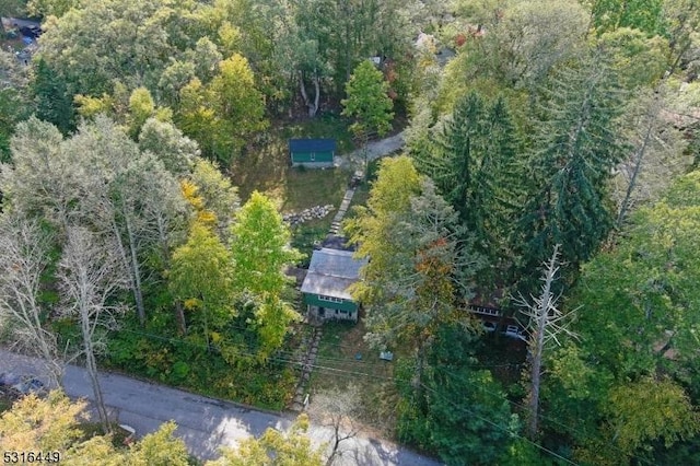 birds eye view of property with a forest view