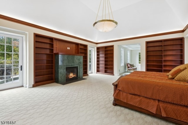 carpeted bedroom with ornamental molding, vaulted ceiling, and access to exterior