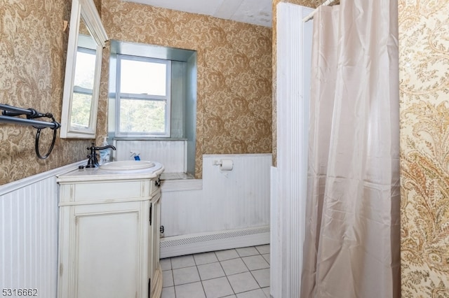 bathroom featuring vanity, a baseboard heating unit, and tile patterned floors