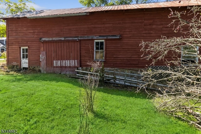 view of side of home with a yard