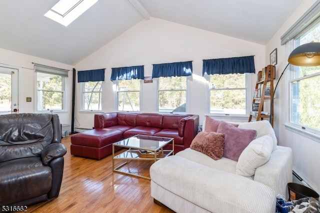 living room featuring a skylight, hardwood / wood-style flooring, plenty of natural light, and beam ceiling