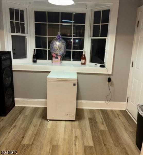 clothes washing area featuring light wood-type flooring