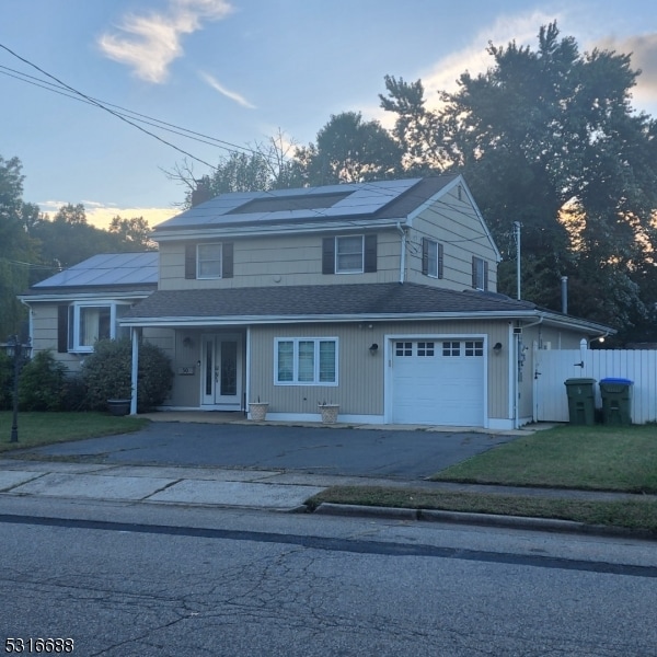 view of property with a front yard and a garage