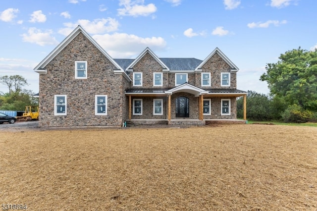 craftsman inspired home with a front yard and covered porch