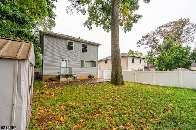 rear view of house with a lawn