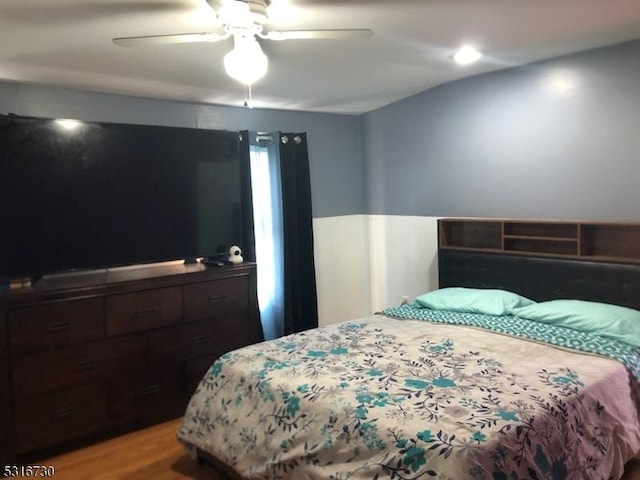 bedroom featuring wood-type flooring and ceiling fan