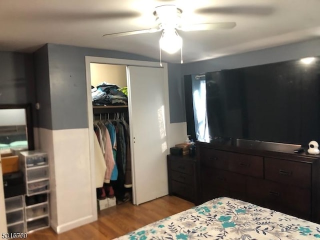 bedroom with ceiling fan, light hardwood / wood-style floors, and a closet