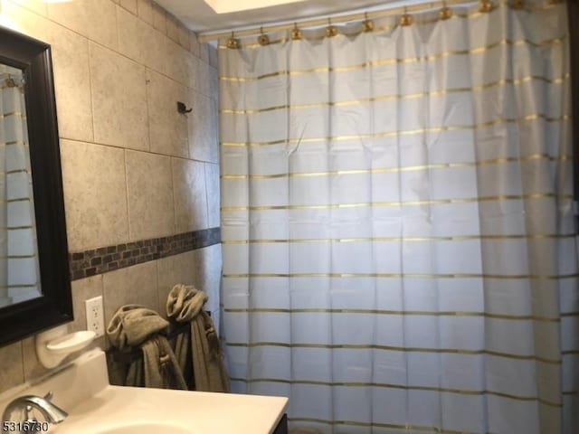 bathroom with tile walls and sink