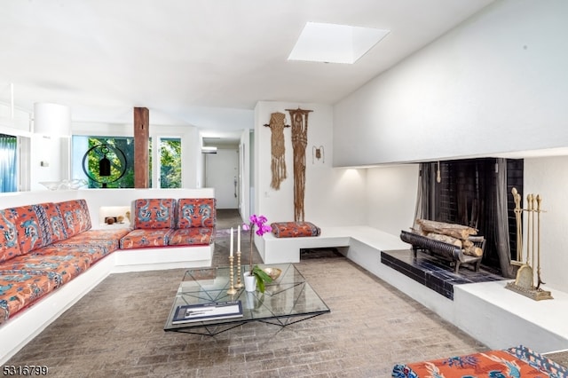 living room featuring carpet flooring and a skylight