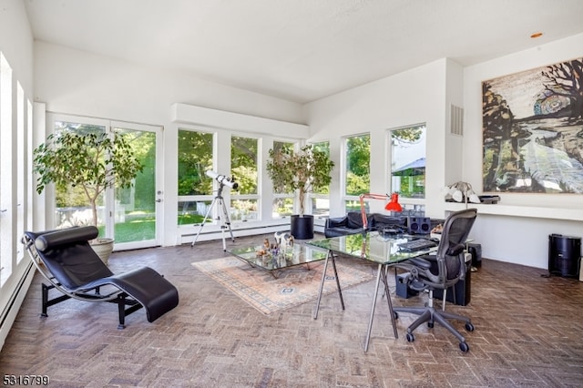 sunroom featuring a baseboard heating unit