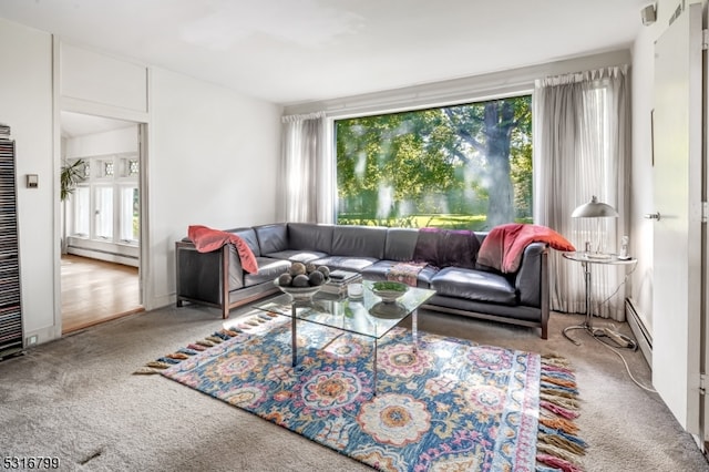 living room with carpet and a baseboard heating unit