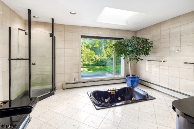 bathroom featuring a skylight, a baseboard radiator, tile walls, and shower with separate bathtub