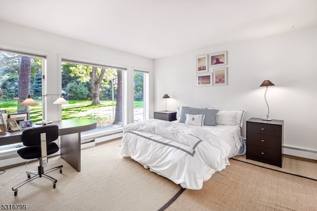 carpeted bedroom featuring baseboard heating