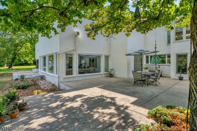 rear view of property featuring a patio area