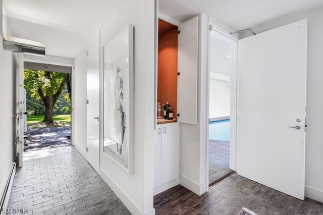 foyer featuring a baseboard heating unit