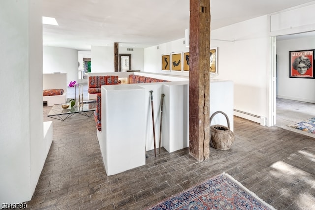 kitchen with a baseboard heating unit and white cabinets