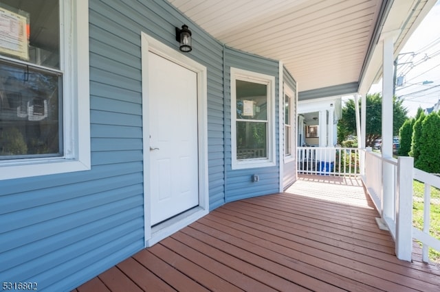 wooden terrace featuring covered porch