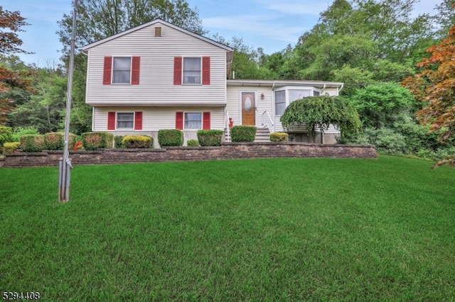 tri-level home with a front lawn