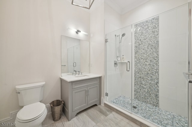 bathroom featuring ornamental molding, an enclosed shower, vanity, and toilet