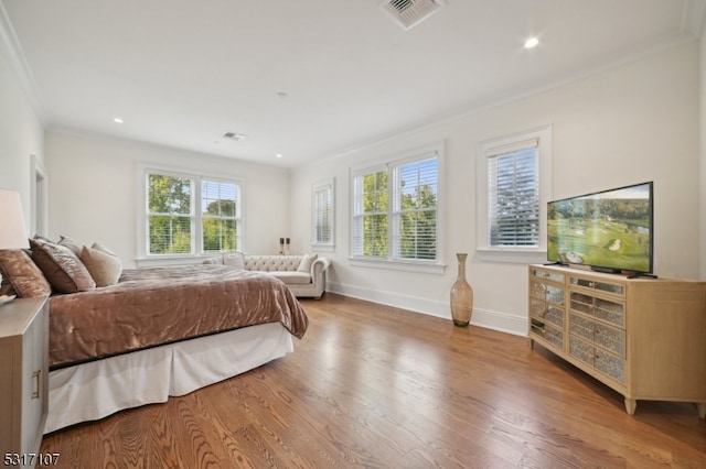 bedroom featuring wood-type flooring and crown molding