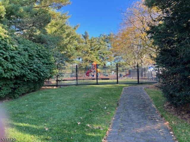 view of community featuring a playground and a lawn