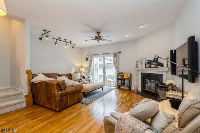 living room featuring ceiling fan and light hardwood / wood-style flooring