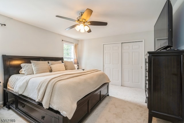 bedroom featuring light carpet, a closet, and ceiling fan