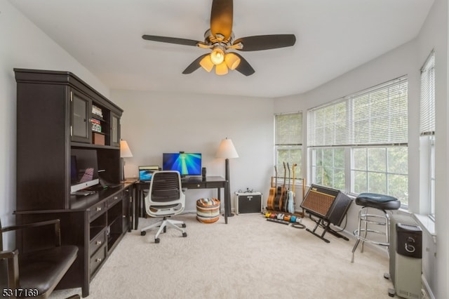 office area featuring light carpet and ceiling fan