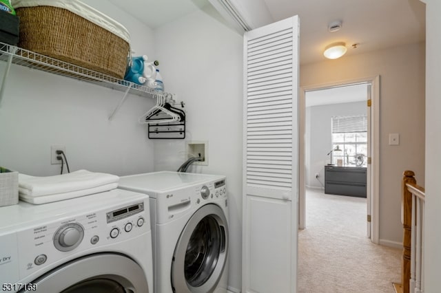 laundry area featuring light carpet and independent washer and dryer