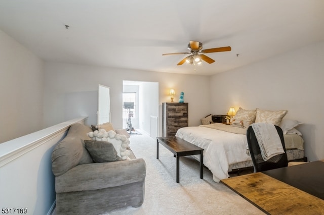 bedroom with ceiling fan and light colored carpet