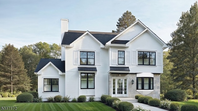 view of front of home featuring a front yard and french doors