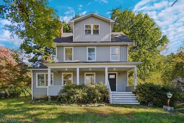 view of front facade featuring a front lawn and covered porch