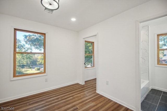 empty room featuring dark hardwood / wood-style floors and plenty of natural light