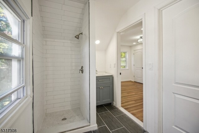 bathroom featuring vanity and tiled shower